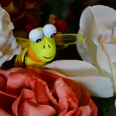 Decided to try macro photography and placed this imitation bee in an arrangement of
imitation flowers hoping Buzz the bee would bring life to the flowers.  
By Jerry Cunnington, 11/1/2021.