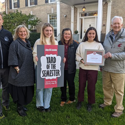 The College Hill Association Board of Directors, Pullman Mayor Glenn Johnson, and Pullman Director of Community Development RJ Lott present the Sorority Yard of the Semester award to Pi Beta Phi chapter president Caroline Ruoff and other members, along with house director Marcia Robinson. The property is located at 825 NE Linden St. in Pullman.