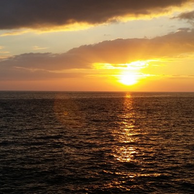 The sun makes a splashy display as it sets over the Pacific on 7/30 in Kona, Hawaii. Photo taken by Donna Safley.