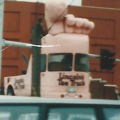 who do you call if your toe falls off? call a toe truck! took this shot while stopped for a red light in seattle in 1994. had to go around the block quite a few times before i finally got a red light.
