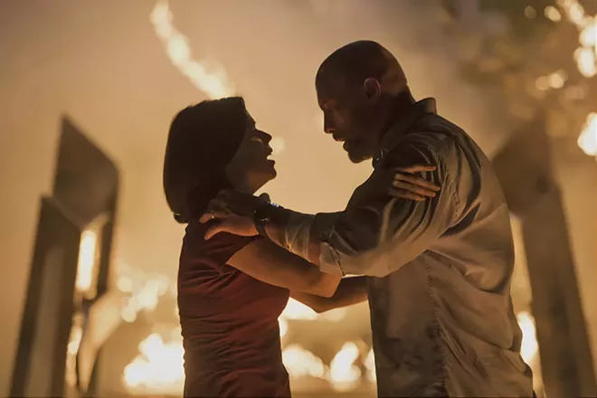 This image released by Universal Pictures shows Neve Campbell, left, and Dwayne Johnson in a scene from "Skyscraper." - KIMBERLEY FRENCH/UNIVERSAL PICTURES VIA AP