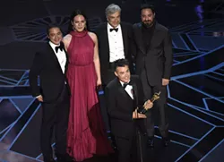 CORRECTS IDS - Sebastian Lelio, foreground center, and Juan de Dios Larrain, background from left, Daniela Vega, Francisco Reyes, and Pablo Larrain accept the award for best foreign language film for "A Fantastic Woman" at the Oscars on Sunday, March 4, 2018, at the Dolby Theatre in Los Angeles. - PHOTO BY CHRIS PIZZELLO/INVISION/AP
