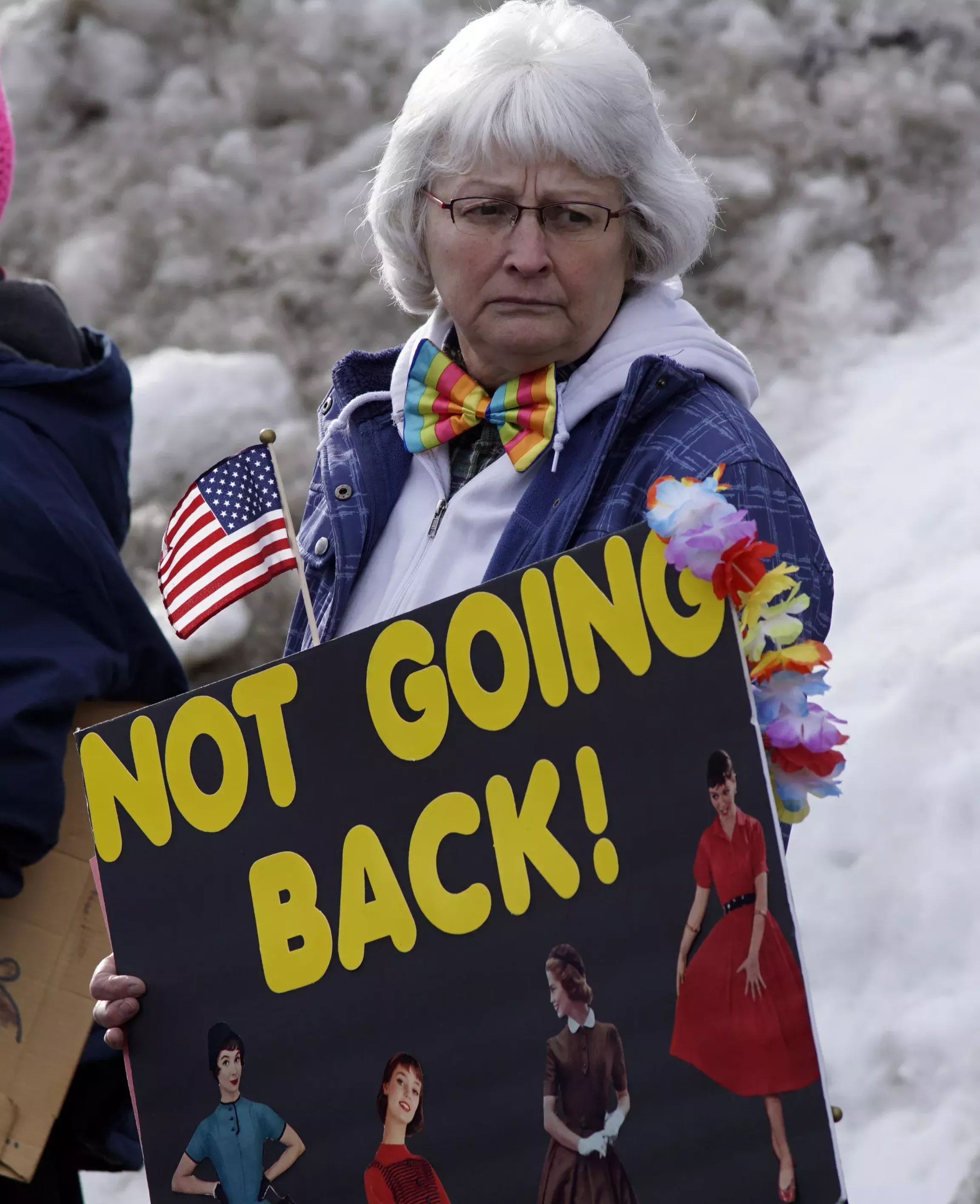 Renee Lam holds a sign while waiting to walk to East City Park with hundreds of others at Moscow's Women's March Saturday afternoon. - KAI EISELEIN