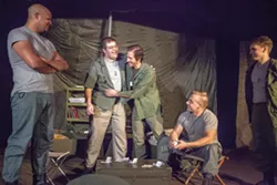 Capt. John "Trapper John" McIntyre, center left, played by Christopher Burns, and Capt. Benjamin Franklin "Hawkeye" Pierce embrace while watched by Capt. John "Ugly" Black, left, played by Brandon Dudley, Capt. Augustus Bedford "Duke" Forrest, far right, played by Jonathan Shumate, and Capt. Walter "Walt" Waldowski, played by Michael Baszler, during rehearsal for the Pullman Civic Theater production of M*A*S*H on Thursday at the Nye Street Theatre in Pullman.