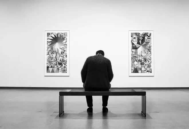 A man contemplates prints by artist Polly Apfelbaum during an opening reception for the exhibit at the Jordan Schnitzer Museum of Art at Washington State University September 4. - KAI EISELEIN/DAILY NEWS