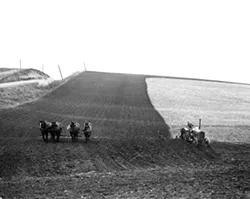 This National Archives photo shows farmers using both a horse-drawn plow and tractor to till a field in Shelby County, Iowa, in 1941. This image is part of the Smithsonian traveling exhibit to be on display at the Lewis-Clark Center for Arts & History in Lewiston.