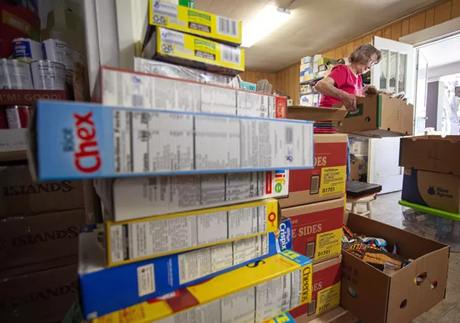 Director Linda Nickels organizes food on Tuesday before opening the Moscow Food Bank. Geoff Crimmins/Moscow-Pullman Daily News - GEOFF CRIMMINS/DAILY NEWS