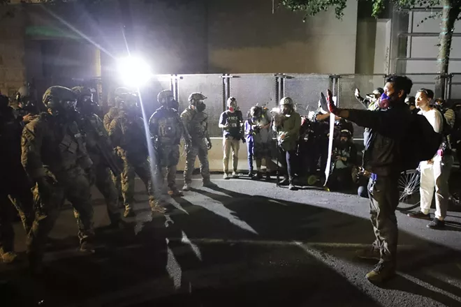 Federal agents keep demonstrators from advancing during a Black Lives Matter protest at the Mark O. Hatfield United States Courthouse Wednesday, July 29, 2020, in Portland, Ore. - AP PHOTO/MARCIO JOSE SANCHEZ