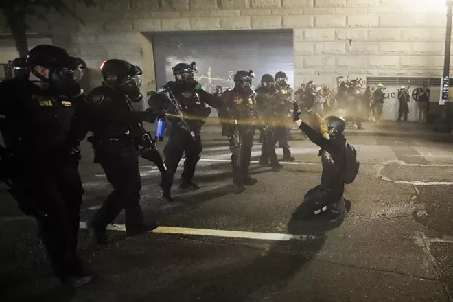 A demonstrator is pepper sprayed shortly before being arrested during a Black Lives Matter protest at the Mark O. Hatfield United States Courthouse Wednesday July 29, 2020, in Portland, Ore. - AP PHOTO/MARCIO JOSE SANCHEZ