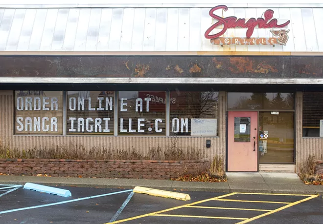 A sign in the window at Sangria Grille reminds customers that they can order online on Thursday in Moscow. - AP