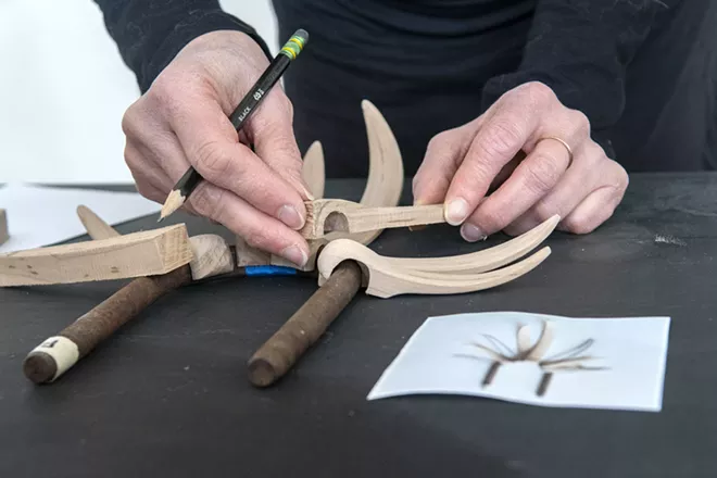 Artist Kristin LeVier works on a project using rusty pieces of metal and wood that she gathered near her remote cabin in Idaho near the Frank Church-River of No Return Wilderness. - ZACH WILKINSON