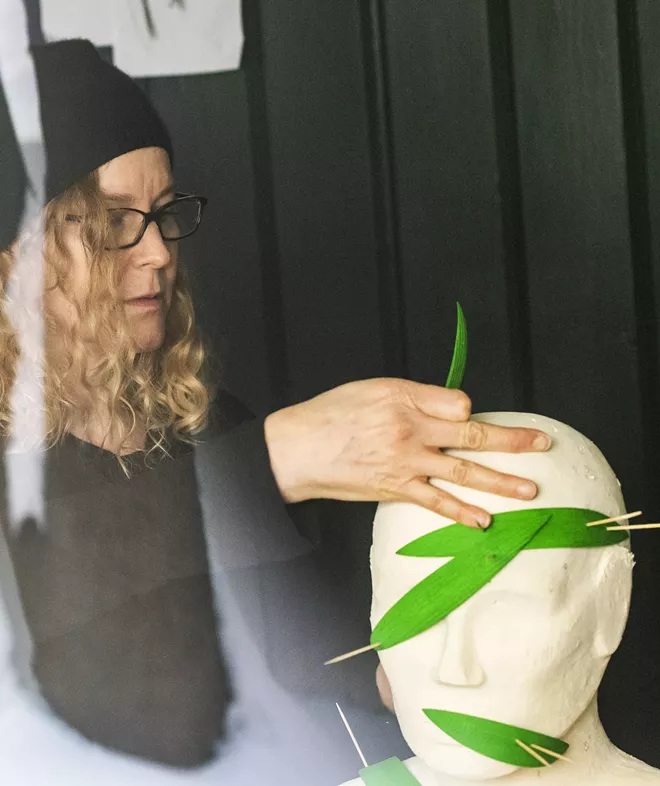 Artist Kristin LeVier is seen working on her most recent project through a window in her basement on a snowy day in Moscow. LeVier said that this was her first work studio with a window and natural lighting. - ZACH WILKINSON