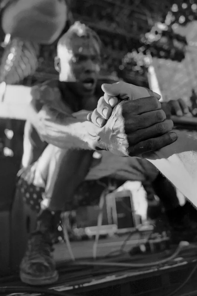 Angelo Moore, frontman for the band Fishbone, reaches out from the stage at The Gorge Amphitheater to grab a fan’s hand in this 1993 photo by Darren Balch. Balch credits his experiences in Pullman for setting him on his path to becoming a rock and roll photographer. - DARREN BALCH