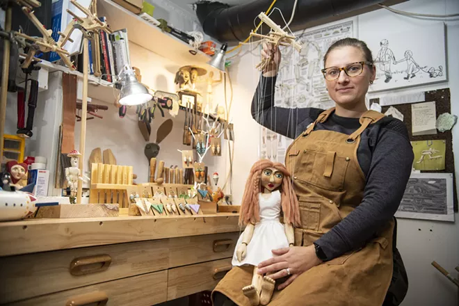 Artist Jana Vrtelova Holbert holds Angel, her favorite of the marionettes she has carved, as she poses for a photo last month in her work studio. “It is very relaxing. You’re making something that’s going to be here forever. I’ve never met my grandfather but I have his work and sketches to live through him,” said Holbert. - ZACH WILKINSON / INLAND 360