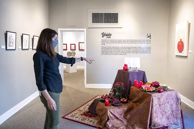 Tirazheh Eslami — an artist, faculty art professor at Lewis-Clark State College and exhibit coordinator — shows a display of food and flowers at her show “Persepolis: Introducing Persian Culture to the West” on Thursday at the Lewis-Clark State College Center for Arts & History in downtown Lewiston. - PETE CASTER/360