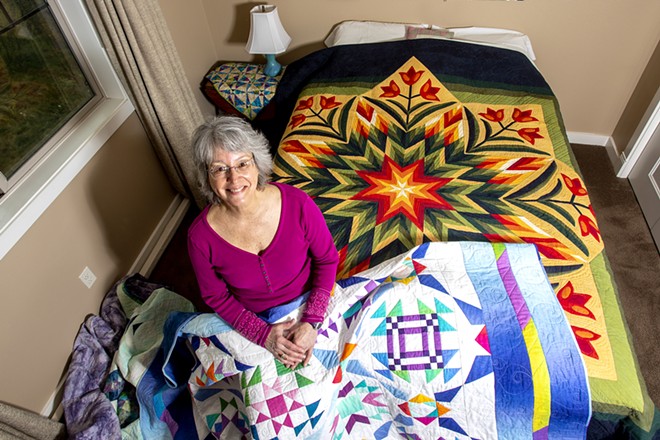 Betty Kendrick poses for a photo with some of her quilts in her Lewiston home. - AUGUST FRANK/INLAND 360