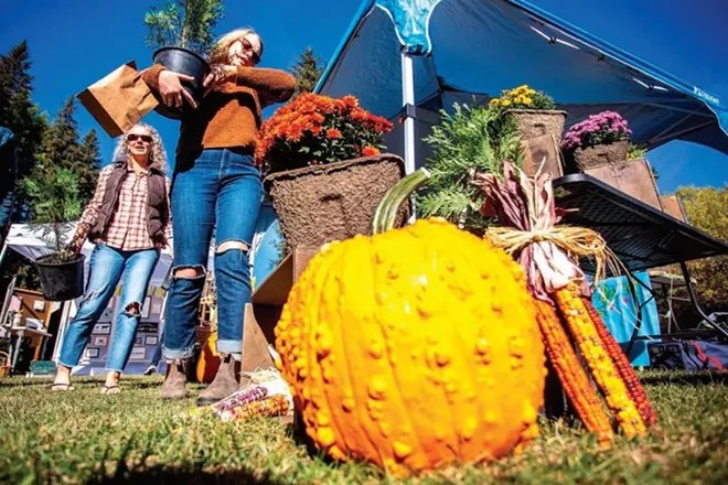 Sydney Beeson and Jennifer Wood (left), of Kendrick, pick out some incense cedar trees from Spring Valley Family Tree Farm’s booth last fall at the Latah Farmers Market in Troy. - AUGUST FRANK/INLAND 360
