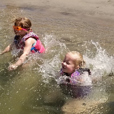 Macie Goin, daughter of Darrin and Tiffany Goin, and Hailey Goin, daughter of Brook Brown and Kody Portlock, jump in the Snake River to cool off from the heat of the sun Saturday, July 21st.