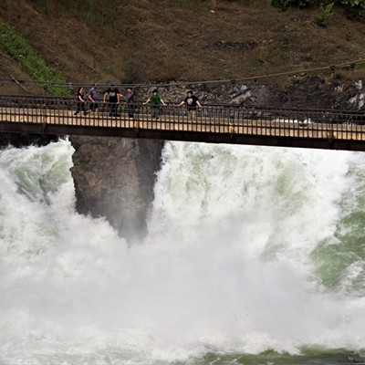 People on the walkway bridge to see the raging water of the Spokane Falls. May 24, 2018 by Mary Hayward.
