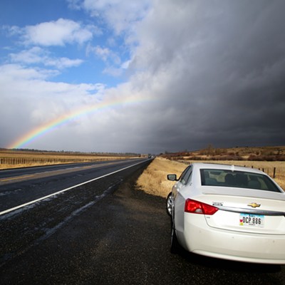 An Iowa car stops to admire the beauty of an Idaho rainbow in a sky mixed with blue and dark storm clouds over the high plains along Hwy 55 just north of Cascade, ID. Photo taken by Keith Collins on November 2, 2018.