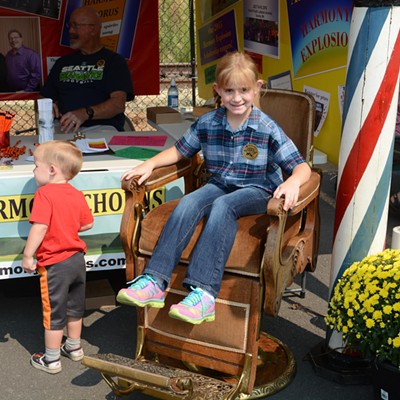 Kayla Windley, 7, tries out the antique barber chair while her brother, Thomas, inspects his daddy&#146;s booth at the National Lentil Festival. They are the children of Tracey and Angela Windley of Moscow. Tracey sings in the ROMEOS barbershop quartet and the Palouse Harmony Chorus. He is a lead hardware engineer at Schweitzer Engineering Laboratory.
    
    The PHC will host an open house 6:45 p.m. on Tuesday, Sept. 15 in the Fellowship Hall of Moscow&#146;s First United Methodist Church, 322 East Third Street.
    
    The antique oak barber chair was originally used in the Pullman Hotel. The wooden barber pole was used in Spokane during the late 1800&#146;s.