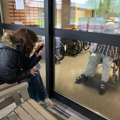 Nancy Orton, of Lewiston, communicates with her dad, Jerry Schrempp, who resides at the Idaho State Veterans Home in Lewiston. She and her sisters visit him every week safely at a distance but in sight through cellphone to keep him updated on all the family news during the coronavirus pandemic.