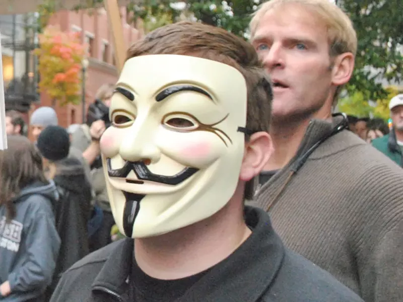 A man wearing a Guy Fawkes mask during an Occupy Spokane march in October - CHRIS STEIN