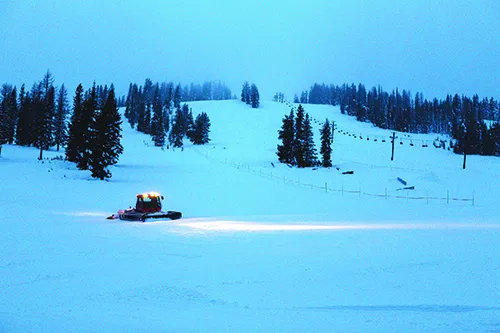 A snowcat finishes an early morning run down the hill. The snowcat will run for 36 hours straight preparing for the weekends.