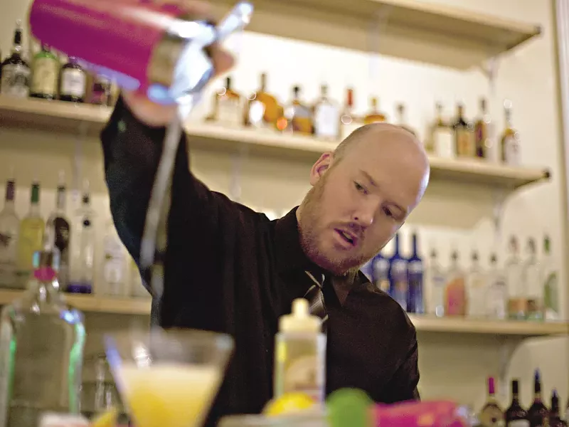 Aaron Mock prepares a pineapple mojito at the Vault Supper Club. - MIKE MCCALL
