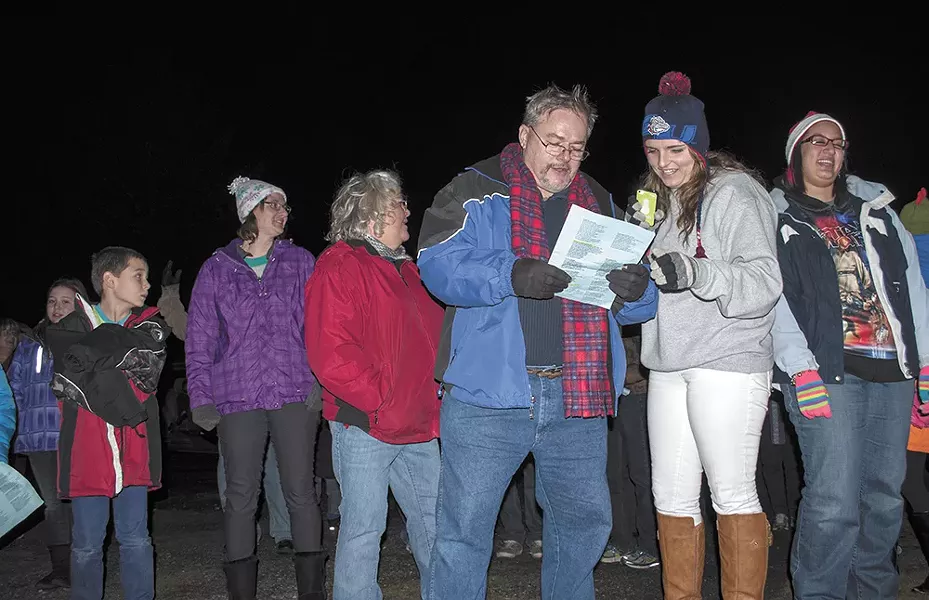 Airway Heights Baptist Church senior pastor Dale Jenkins (left) leads friends and family caroling around nearby neighborhoods. - SARAH WURTZ