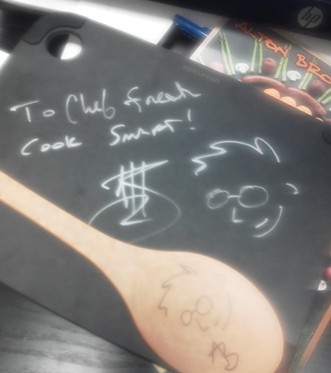 Brown signed Kyle Bowlby's (his nickname is "Chef Freak") cutting board and spoon since the Wandering Table sous chef couldn't attend the show last night.