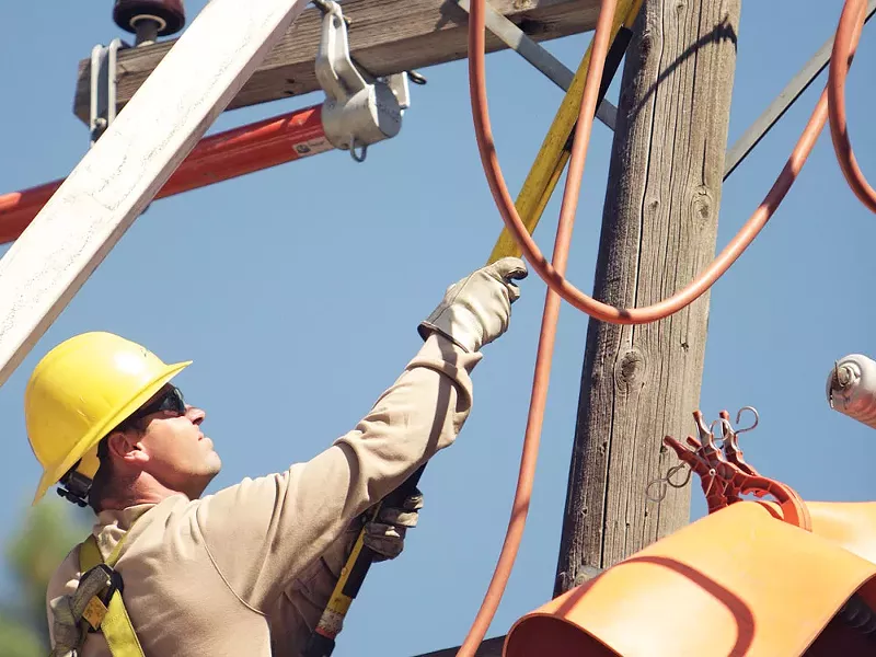 Avista worker Clay Grant tempts fate. - YOUNG KWAK