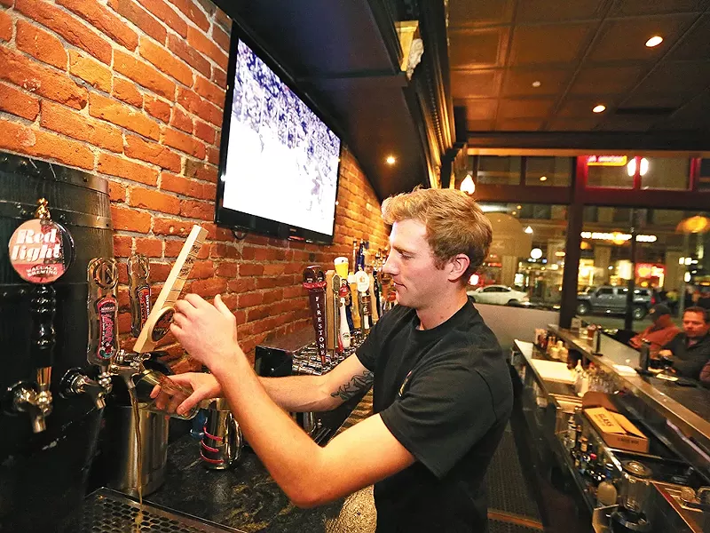 Bartender Levi Alford pours a beer at Post Street Ale House. - YOUNG KWAK