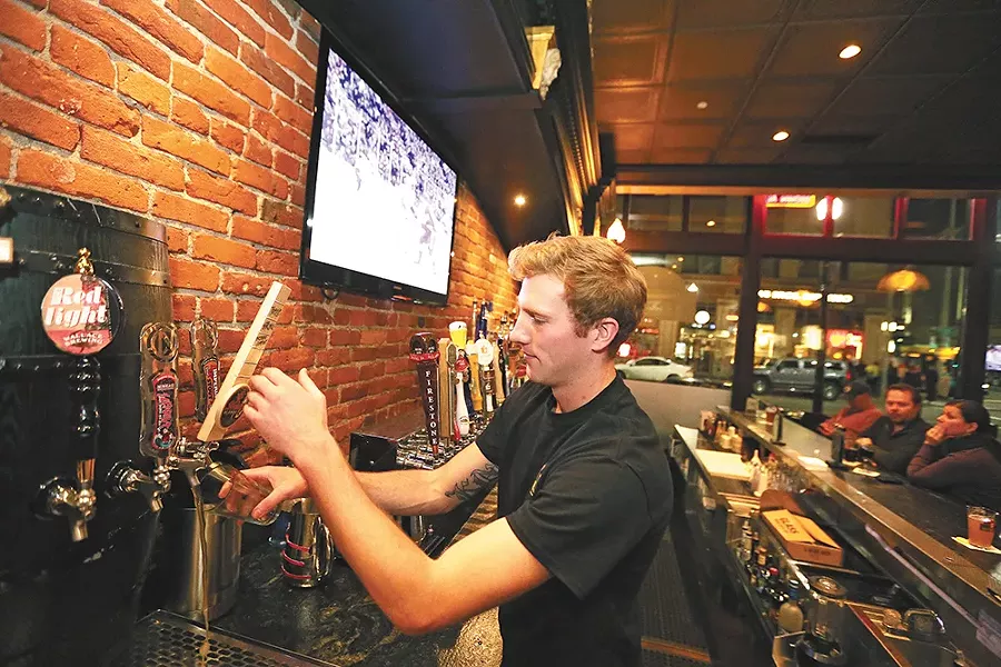 Bartender Levi Alford pours a beer at Post Street Ale House. - YOUNG KWAK