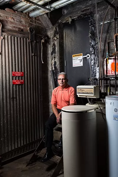 Bill Bancroft in front of the door leading to a tunnel system in downtown Spokane. Although there are smaller self-contained tunnel systems in the city, the tunnels originating from the Steam Plant used to heat downtown and are assumed to be the most extensive network. Access is guarded by an alarm and a locked door that even Bancroft isn’t allowed to open. - STEPHEN SCHLANGE