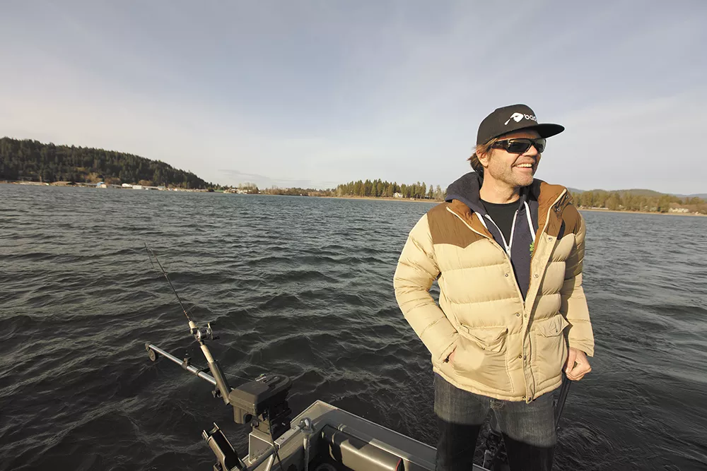 Brad Fosseen fishes area waterways year-round. His gear includes a 22-foot North River fishing boat, fake squid lure and rod with Shimano reel. - YOUNG KWAK