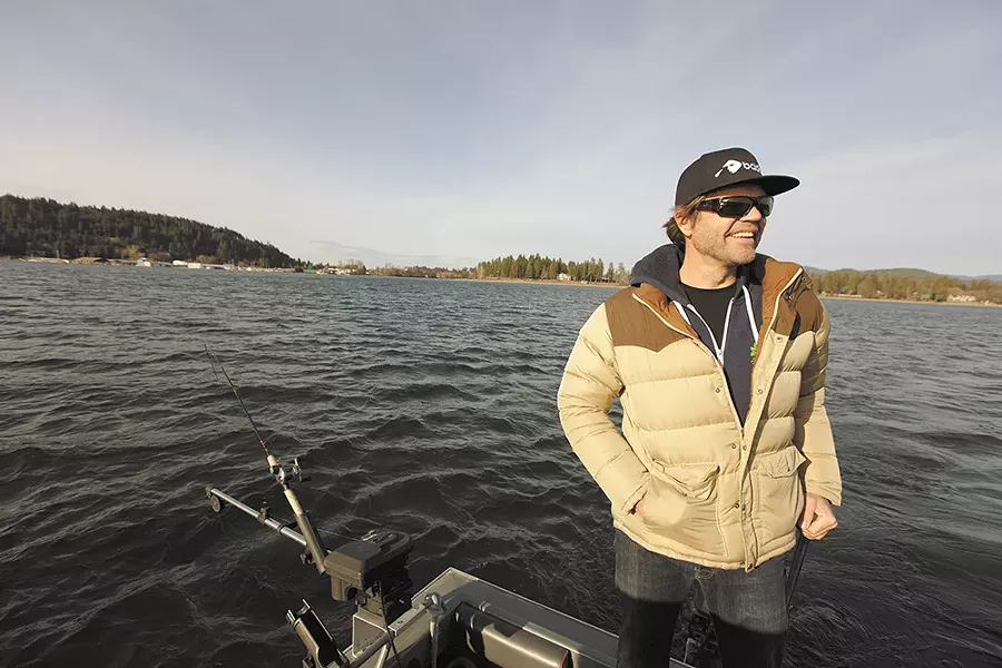 Brad Fosseen fishes area waterways year-round. His gear includes a 22-foot North River fishing boat, fake squid lure and rod with Shimano reel. - YOUNG KWAK