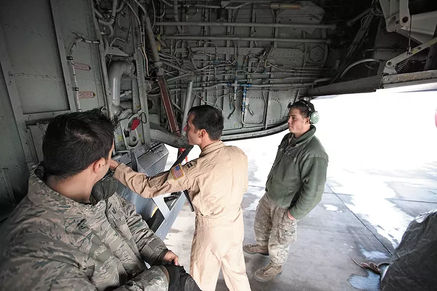 Captain Mike Dobbs, right, checks the wheel well of a KC-135 at Manas, as Senior Airman Nick Stevens looks on. - YOUNG KWAK