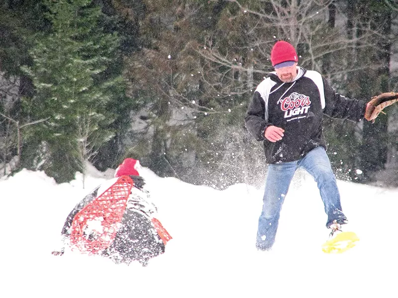 Catching a softball is complicated by snowshoes. - PECKY COX