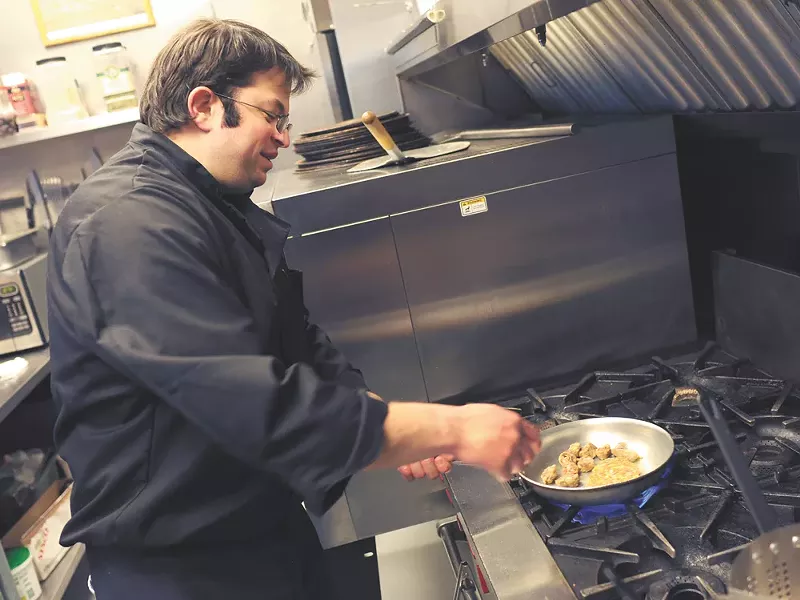 Chef Telly Karatzas prepares a dish at Cafe Italiano\'s new location on the South Hill