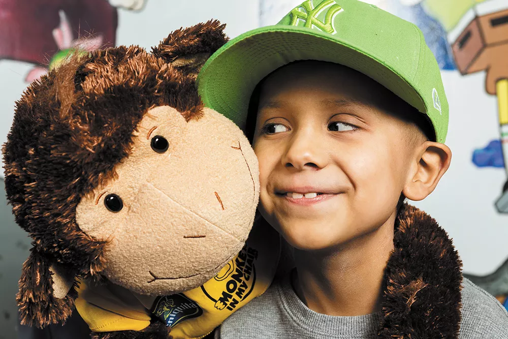 Cole Whitworth with the furry friend that helped him stay connected to home in Montana during his cancer treatments. - STEPHEN SCHLANGE
