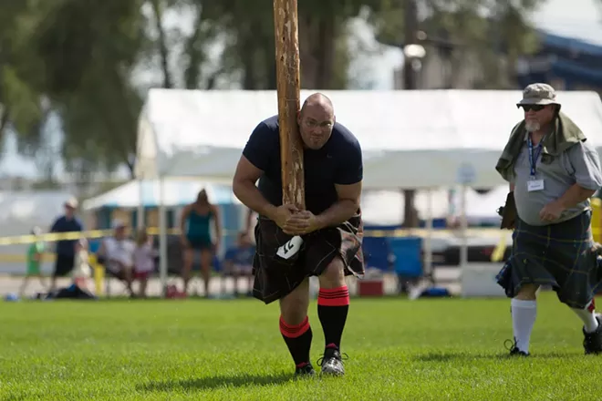 Cory Frazier, from Tacoma, Wash., walks with a caber during the men's amateur A & B competition. - YOUNG KWAK