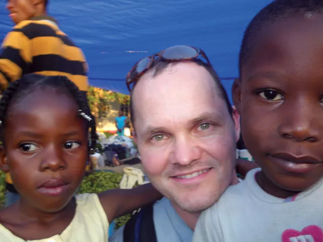 Dr. Mathew Rawlins with two Haitian children in January.
