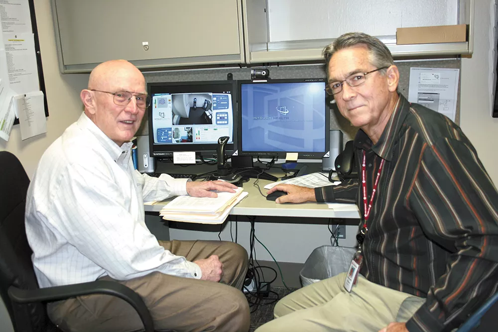 Dr. William Terry (left) and Dr. William Hazle use this terminal to communicate with patients in rural areas. - ST. ALPHONSUS REGIONAL MEDICAL CENTER