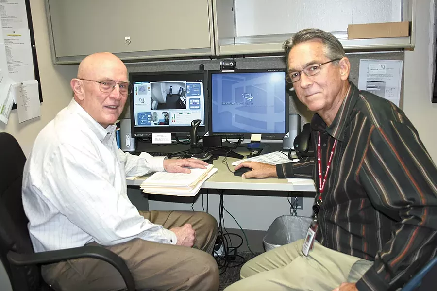 Dr. William Terry (left) and Dr. William Hazle use this terminal to communicate with patients in rural areas. - ST. ALPHONSUS REGIONAL MEDICAL CENTER