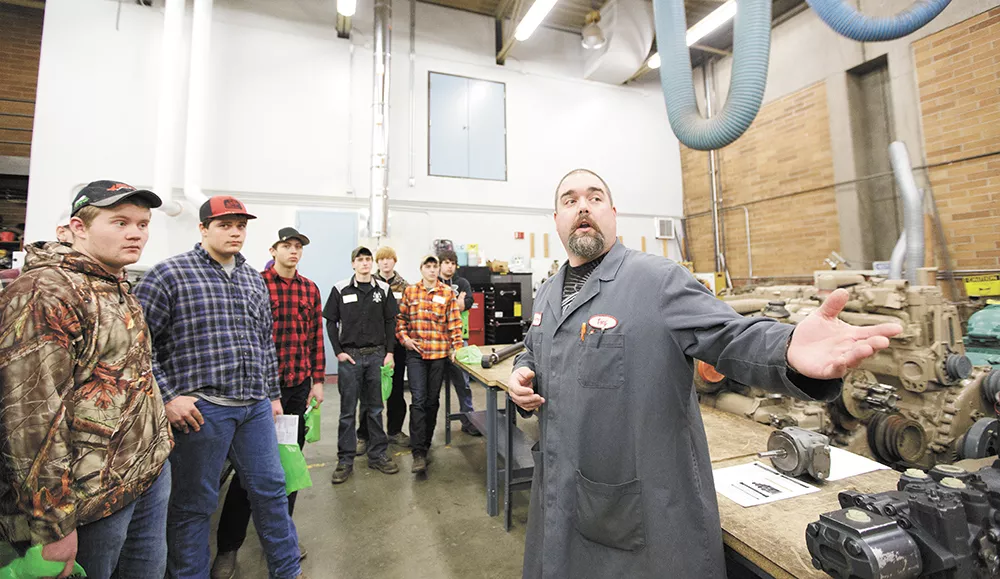 During a tech tour at North Idaho College, Diesel Technology Instructor Tony Christiansen shows a group of high school students options at the institution. - YOUNG KWAK