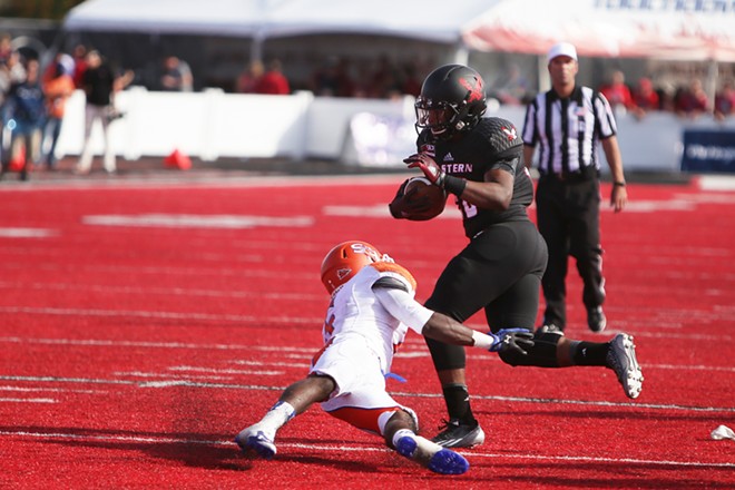 Eastern Washington running back Jalen Moore, right, runs the ball against Sam Houston State cornerback Mikell Everette during the second half. - YOUNG KWAK