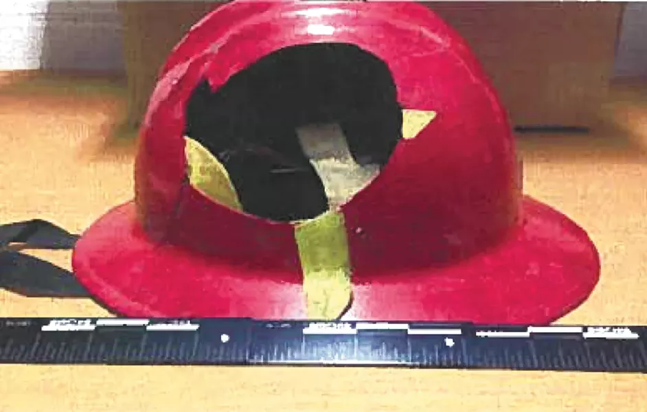 Evidence photos show the damage to Hall's helmet.