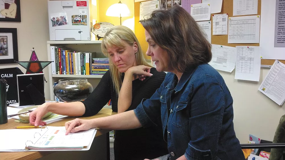 Finch Elementary Principal Kim Harmon (left) and second-grade teacher Theresa Luciani work together using the district's new, more rigorous teacher evaluation system. - DANIEL WALTERS