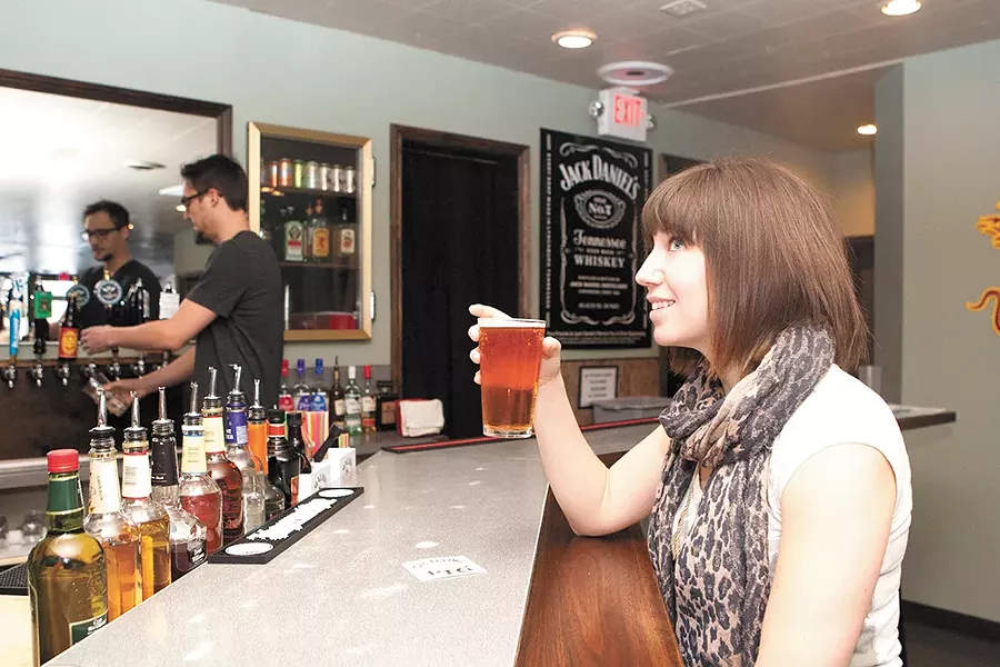 Gina Thompson enjoys a cold one at the Flying Pig Pub. - MEGHAN KIRK